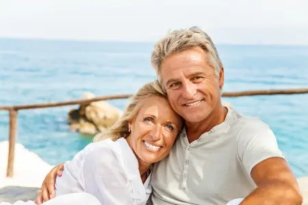 19245338 - mature couple smiling and embracing