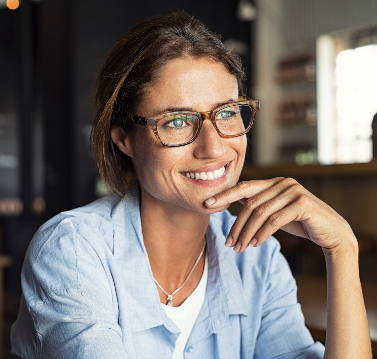 Smiling woman wearing spectacles Minimally Invasive Skin Tightening in McLean, VA