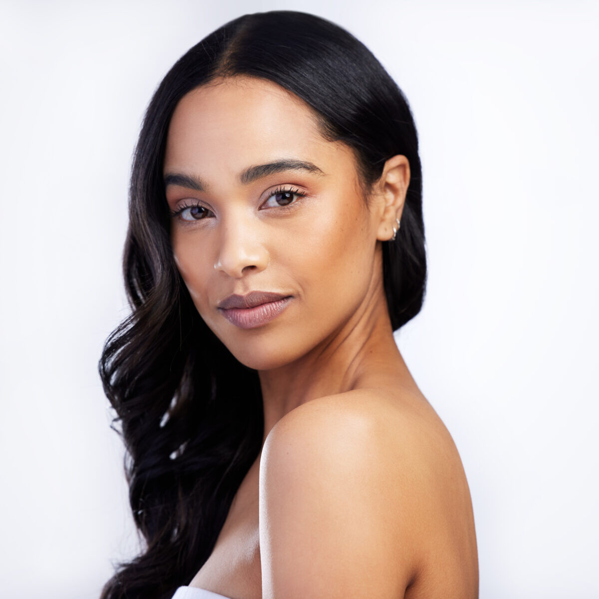 Shot of an attractive young woman standing alone in the studio Kybella® in McLean, VA